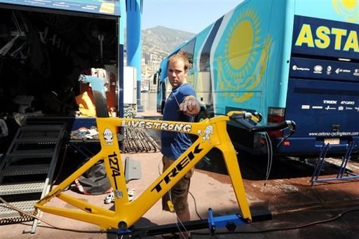An Astana mechanic begins assembly of Lance Armstrong's time trial bike.