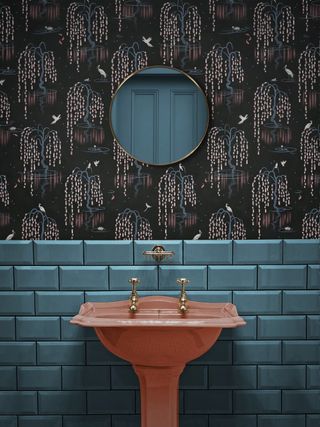 Powder room with botanical wallpaper and coral colorful sink by Divine Savages