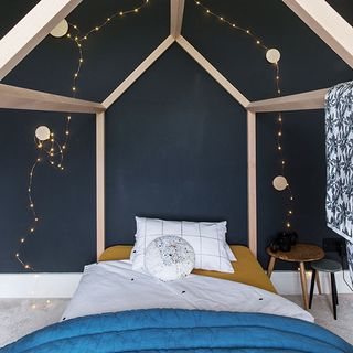 bedroom with black wall with lighting