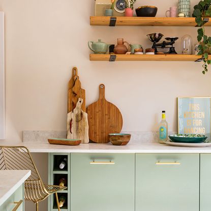 kitchen with green cabinets and white worktop