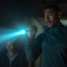 aaron pierre shines a flashlight in a still from the movie rebel ridge