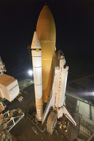 Space shuttle Discovery, secured to a crawler-transporter, slowly moves away from Launch Pad 39A at NASA's Kennedy Space Center in Florida, on its way to the Vehicle Assembly Building for repairs to its external fuel tank.