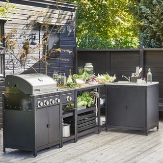 outdoor kitchen with storage units, freestanding modular units, BBQ, open shelving, all on decking