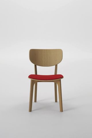 Wooden chair with red seat pad