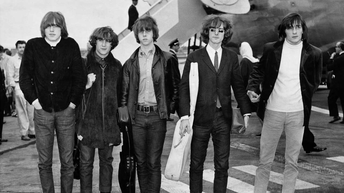 The Byrds standing on the tarmac next to an aeroplane