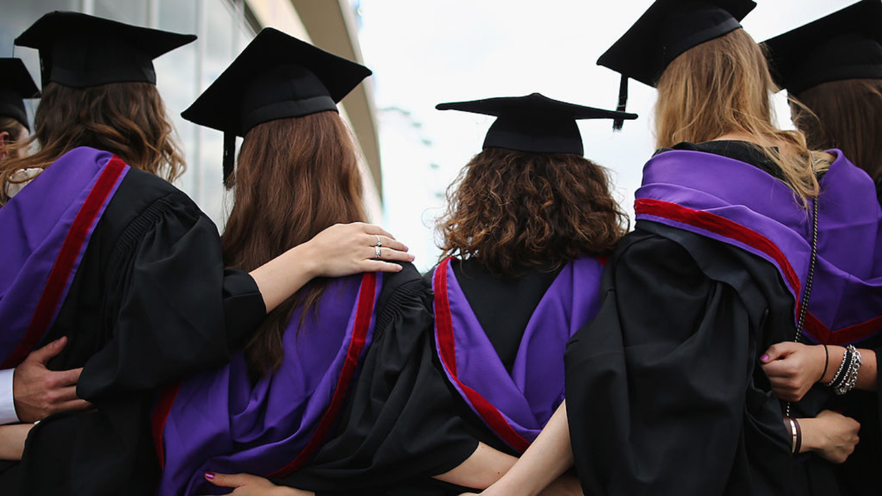 Graduates pose for photograph