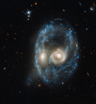 The Hubble Space Telescope's Advanced Camera for Surveys captured this image of two merging galaxies collectively known as Arp-Madore 2026-42.