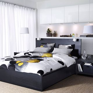 bedroom with white curtains and black bed