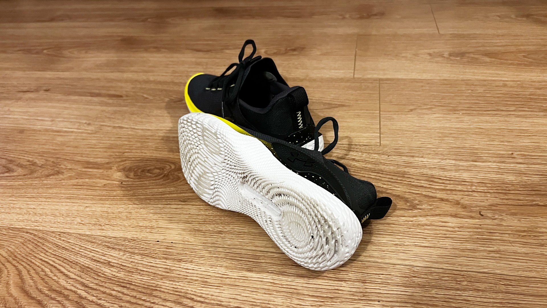 UA Flow Dynamic training shoe with outsole on show against wooden floor