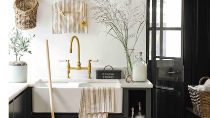 laundry room organization ideas with basin, gold tap and patterned towel