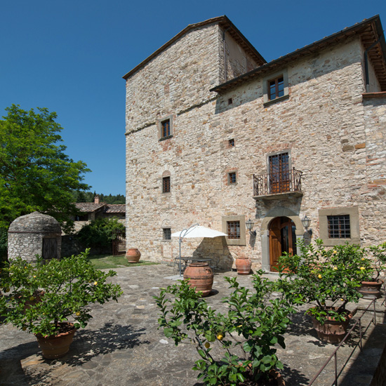 house with exposed brick wall wooden door and garden
