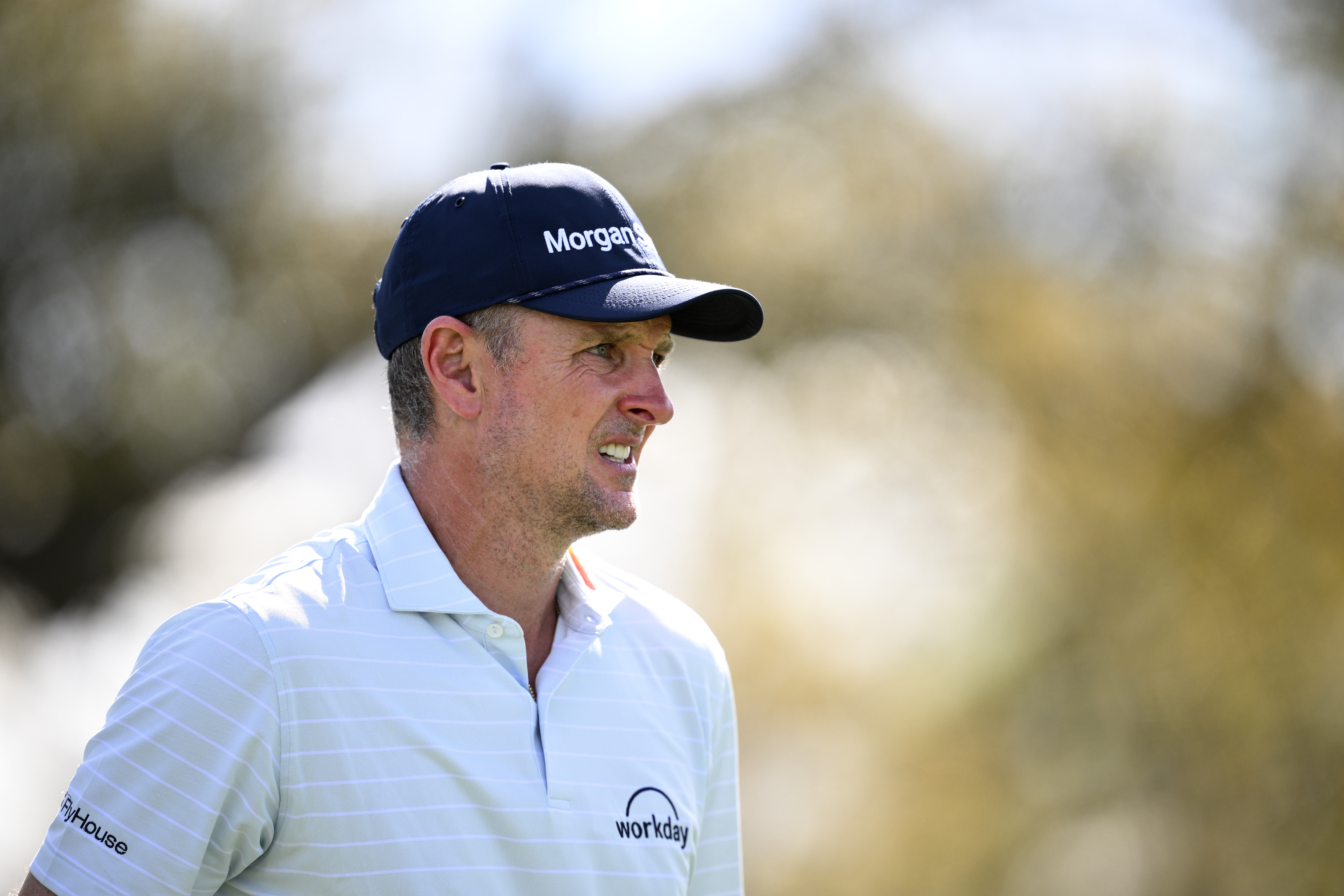 Justin Rose winces as he walks off the green