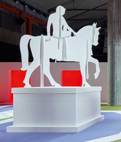 Left: Rem Koolhaas, equestrian statue. Right: Print of model in long brown coat
