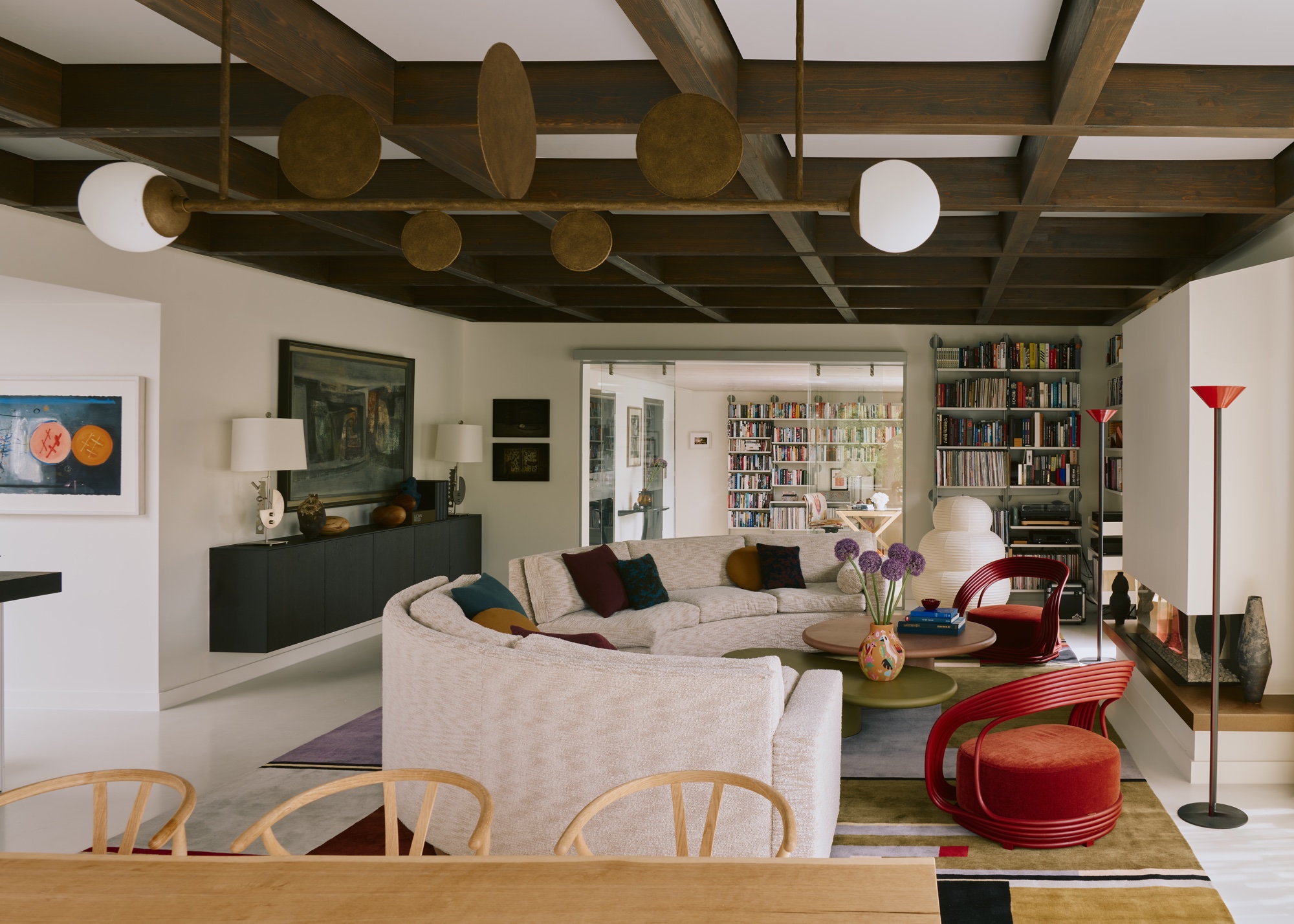Living room with curved showing a layered lighting scheme by Maddux Creative