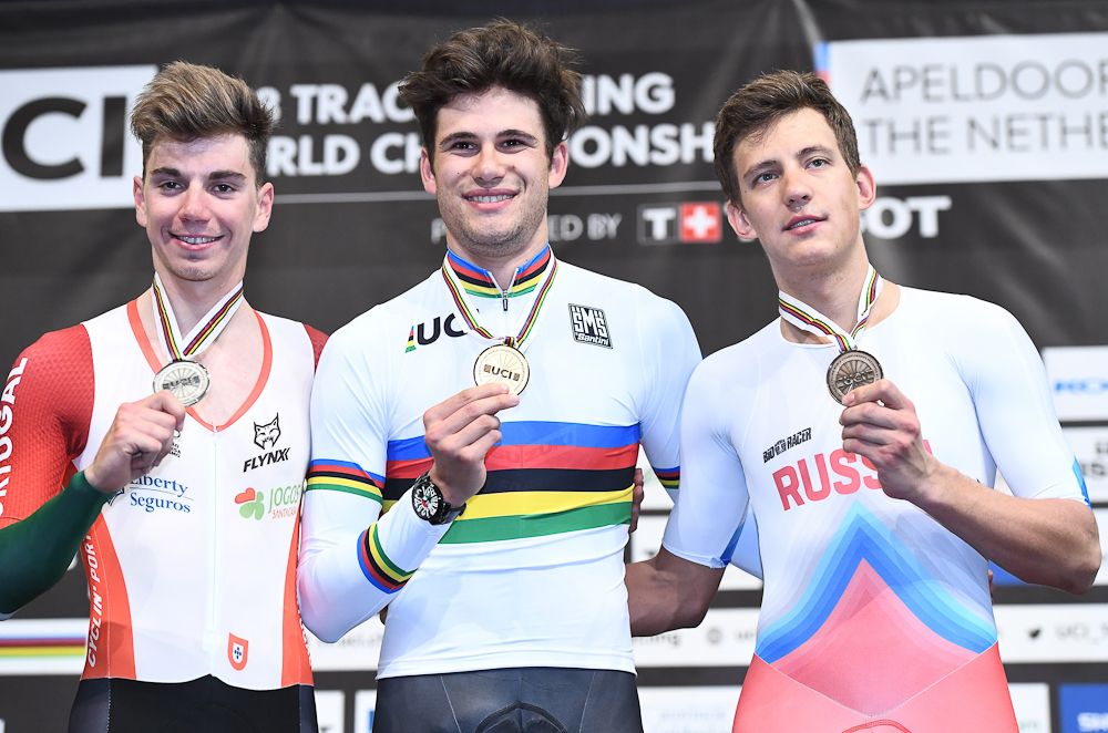 Silver medallist Portugal's Ivo Oliveira, Gold medallist Italy's Filippo Ganna, and Bronze medallist Russian Alexander Evtushenko pose on the podium after the men's individual pursuit
