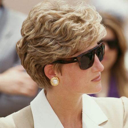Princess Diana wearing sunglasses and a tan blazer looking to the right