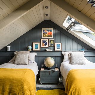 attic room with beds and indigo blue wall