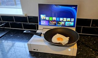 An egg frying in a pan on top of an Xbox Series S