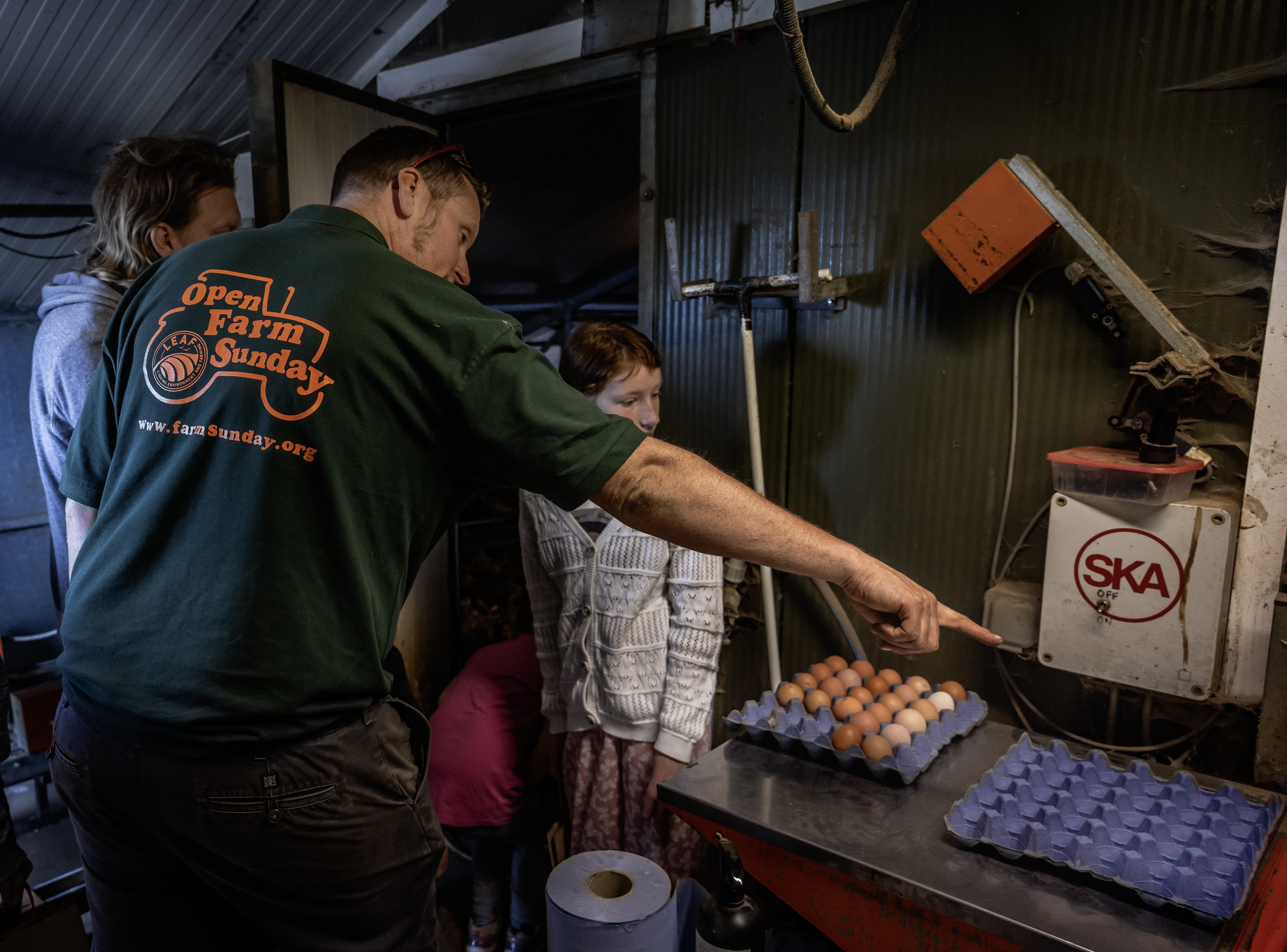A farmer showing a child some eggs