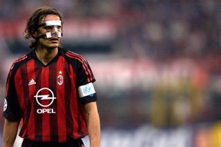 AC Milan captain Paolo Maldini, wearing a protective mask, looks on during the Champions League quarter-final second leg match against Ajax at San Siro in Milan, Italy, April 2003.