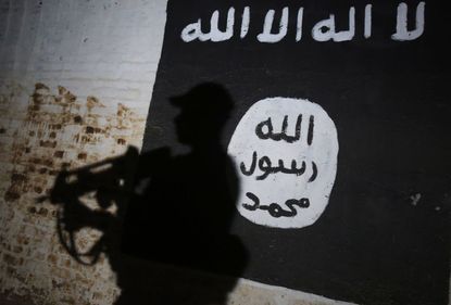 An ISIS flag painted on a wall.