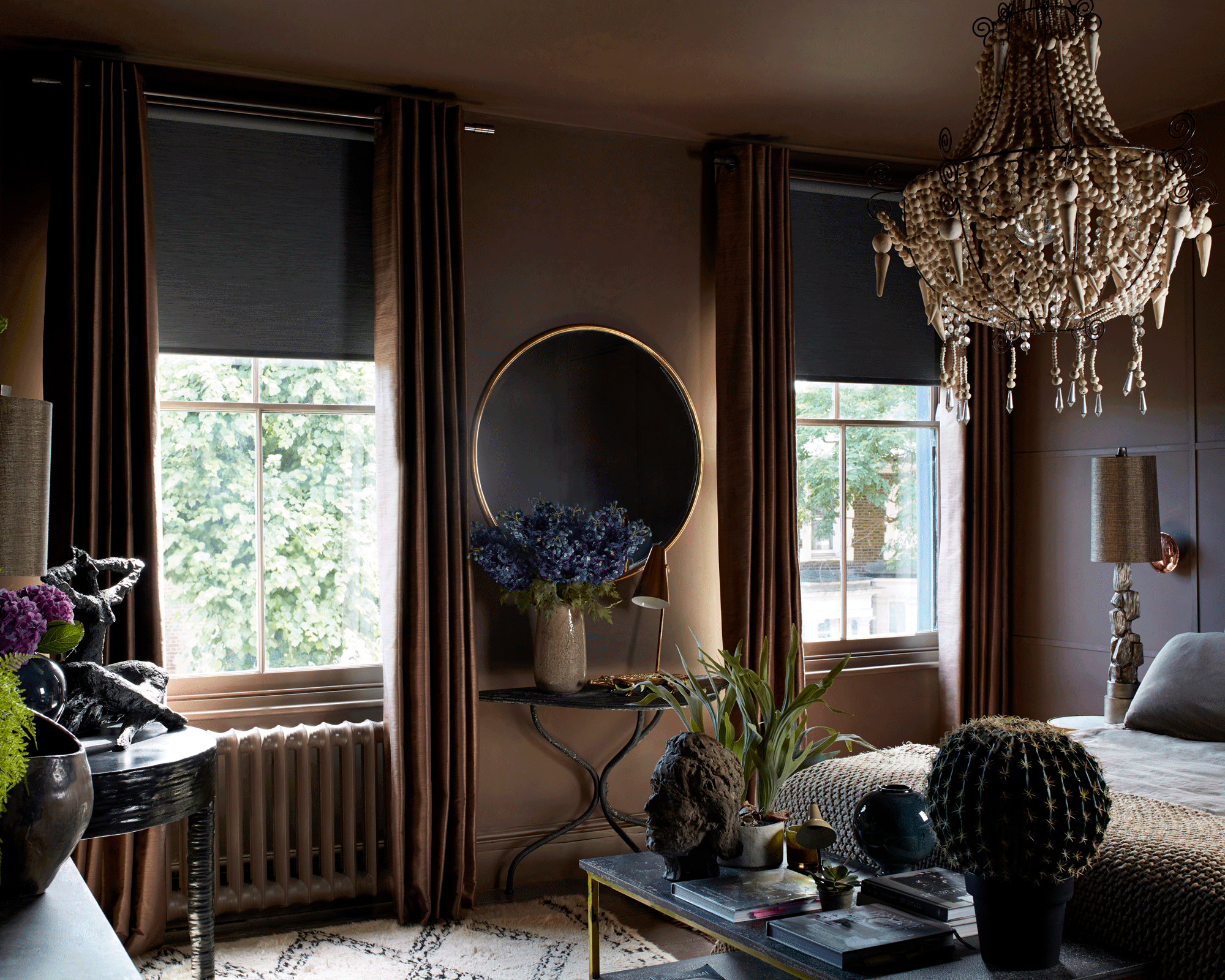 Dark bedroom with chandelier and two windows