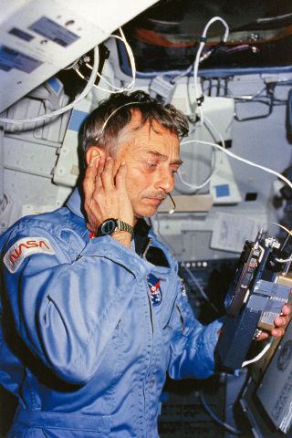 STS-9 mission specialist Owen Garriott uses a ham radio on space shuttle Columbia to contact radio operators on Earth.