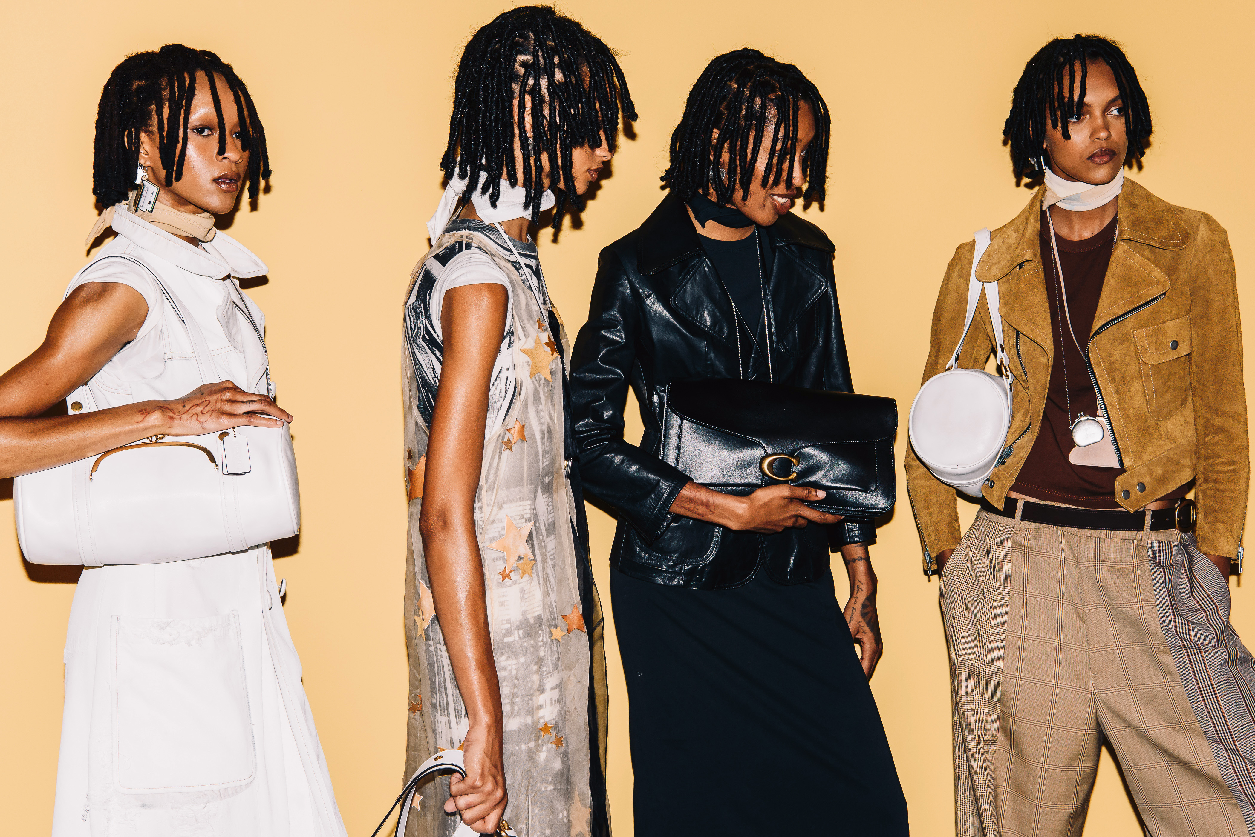 four models wearing Coach bags backstage at the coach show