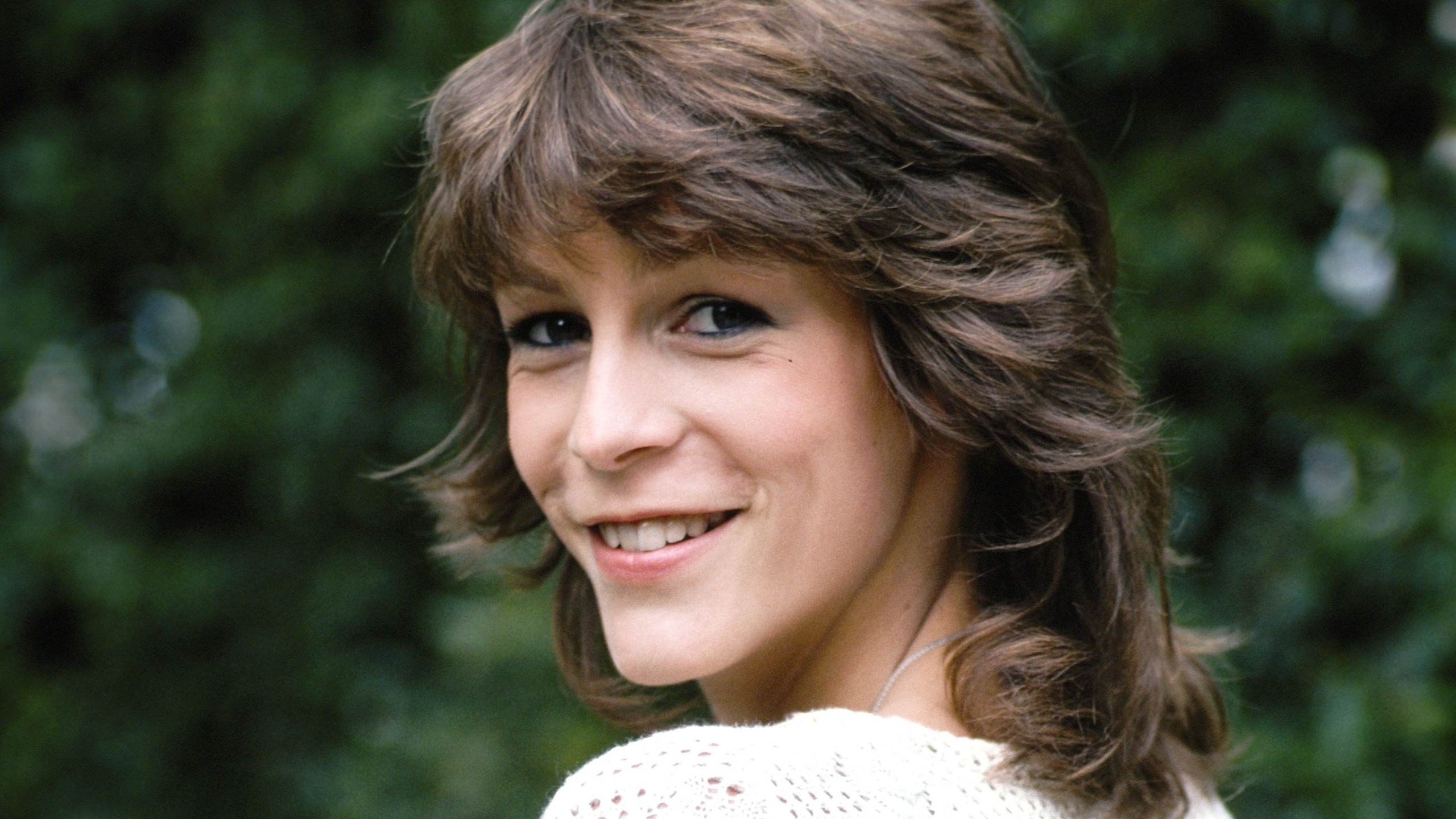 Jamie Lee Curtis on a green background