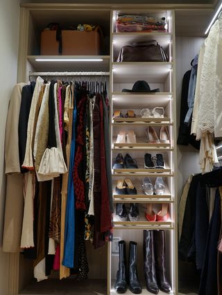 A portion of Kat's closet with her shoes, organized box, and long dresses hung up.