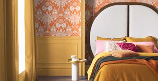 70s inspired bedroom trend 2023 with orange wallpaper and ochre bedding