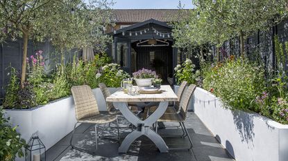 An outdoor dining table in a small garden