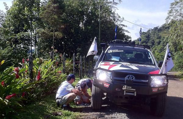 The drivers try (unsuccessfully) to fix the media vehicle. It had to get towed out.