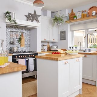 kitchen with white wall and vegetables on wooden worktop