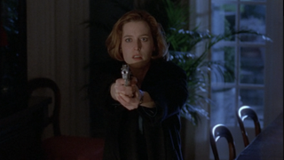 Scully pointing a gun at Mulder in the "Wetwired" episode of The X-Files
