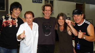 AC/DC’s Angus Young, Malcolm Young and Brian Johnson with the Rolling Stones’ Ronnie Wood and Keith Richards backstage at a gig