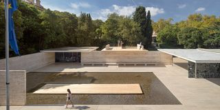 wooden pavilion in mies van der rohe barcelona pavilion showcasing merging of two pavilions shot from above