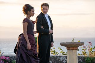 Alisha Boe and Josh Dylan stood by the coast in The Buccaneers
