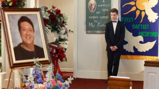 Sheldon looking at his father's casket