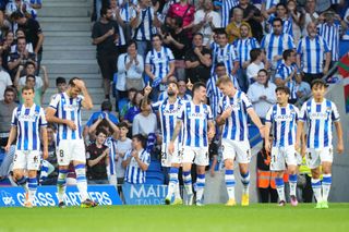 Brais Mendez of Real Sociedad celebrates with teammates after scoring their team's first goal during the LaLiga Santander match between Real Sociedad and Villarreal CF at Reale Arena on October 09, 2022 in San Sebastian, Spain.