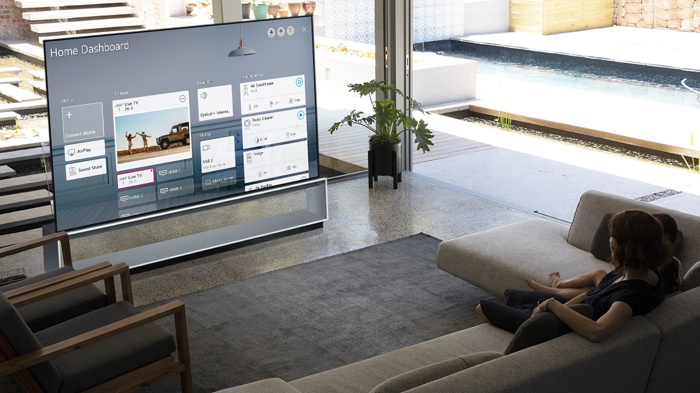 LG Signature ZX 8K OLED in a grey living room with wide windows