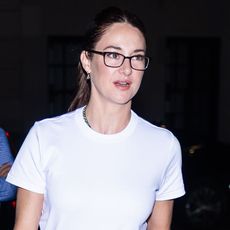 Shailene Woodley wearing a white T-shirt, leopard print pants, and pointed-toe shoes 