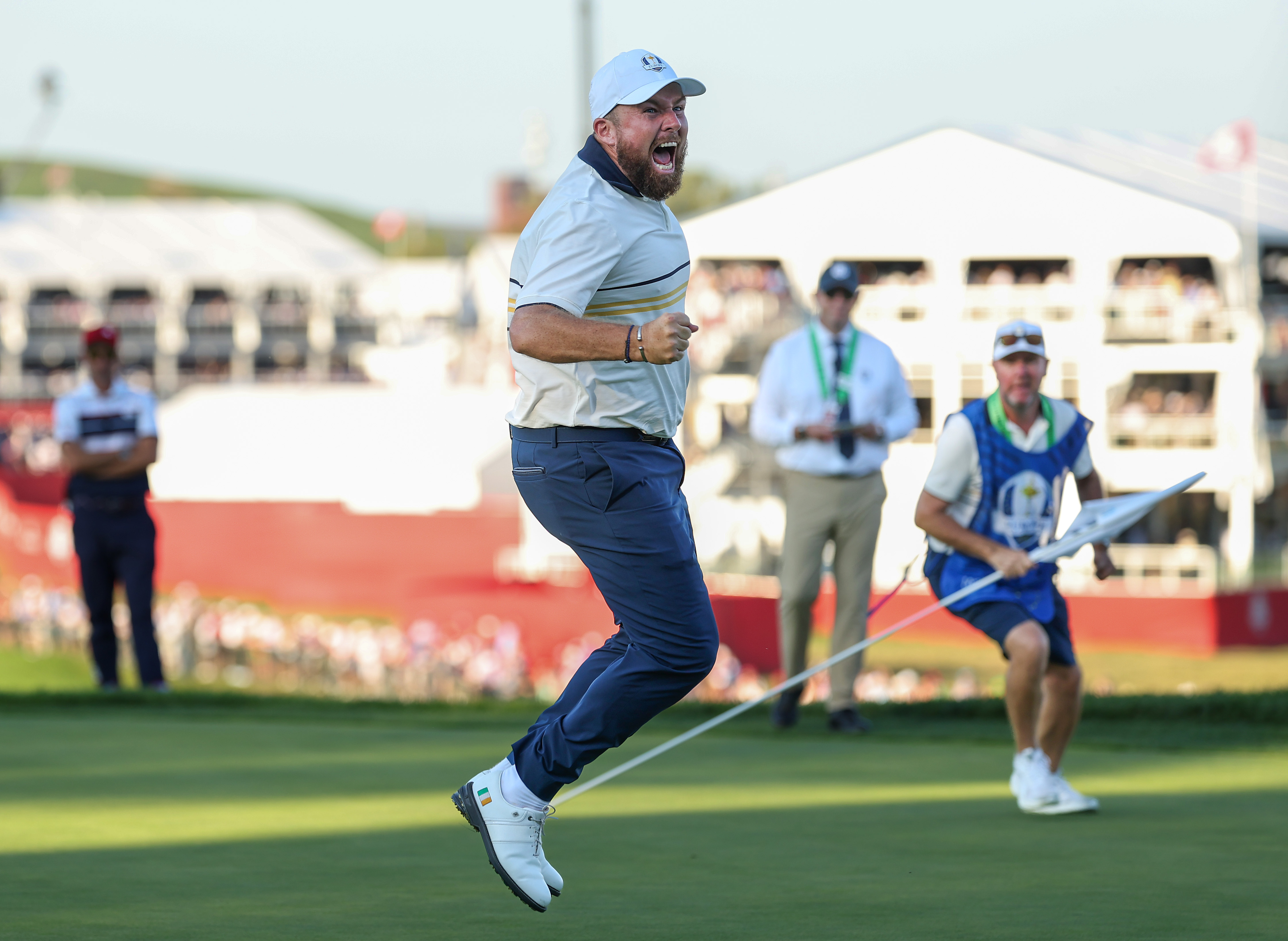 Shane Lowry jumps in the air after holing the winning putt
