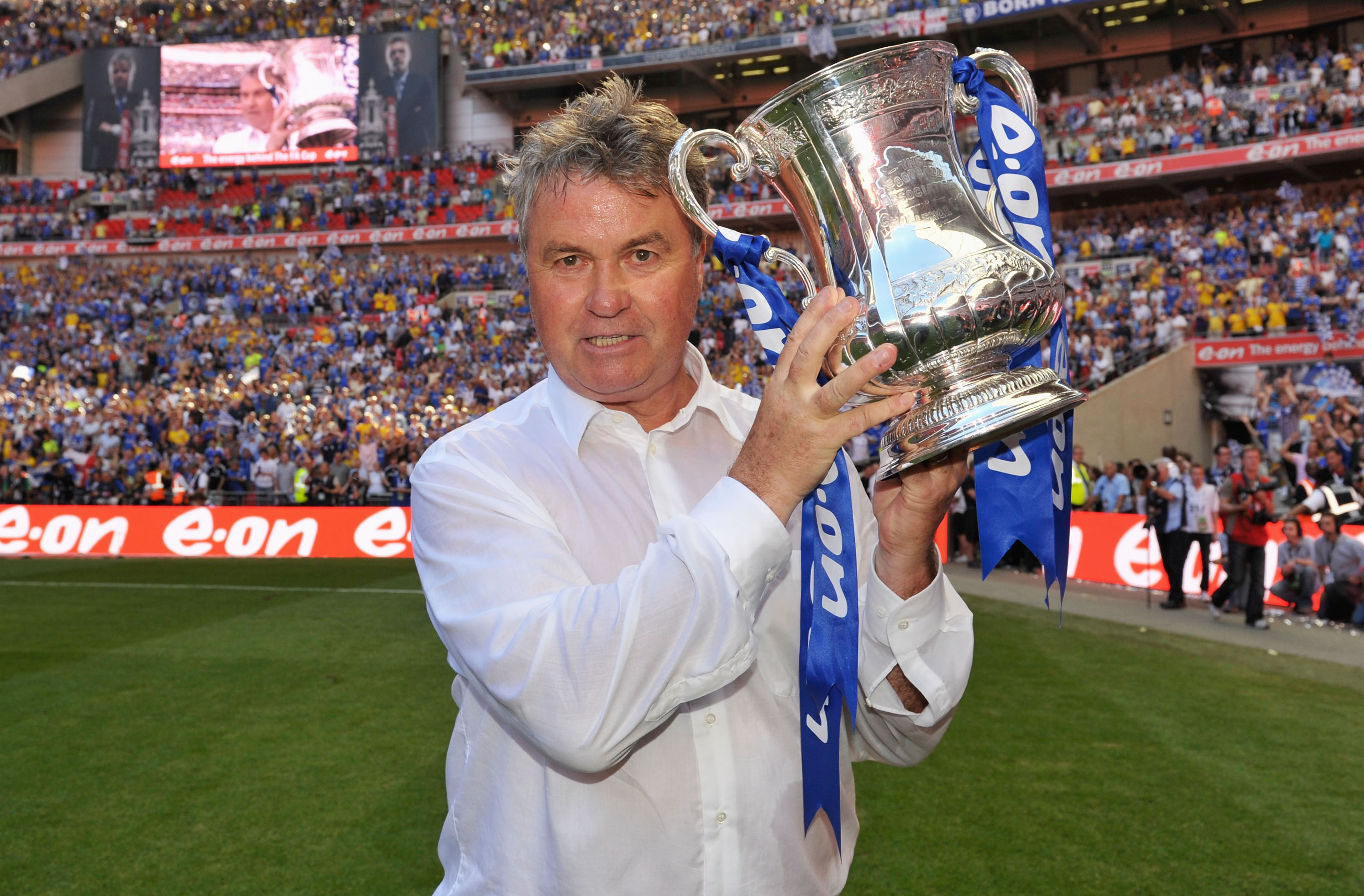 Guus Hiddink celebrates with the FA Cup after Chelsea's win over Everton in the final in May 2009.