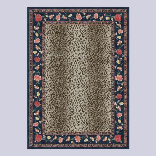 Image of a cheetah print rug with a navy blue and red floral border on a lavender background.