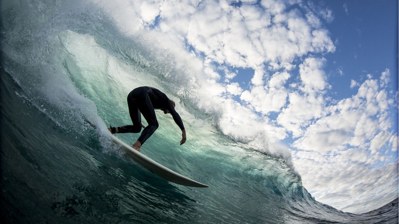 A surfer rides a big wave.