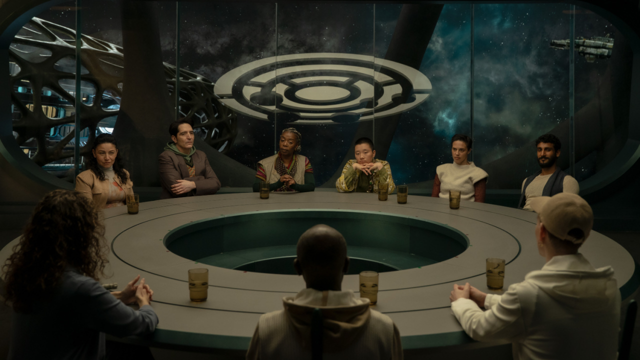 A group sitting around a table in Murderbot.