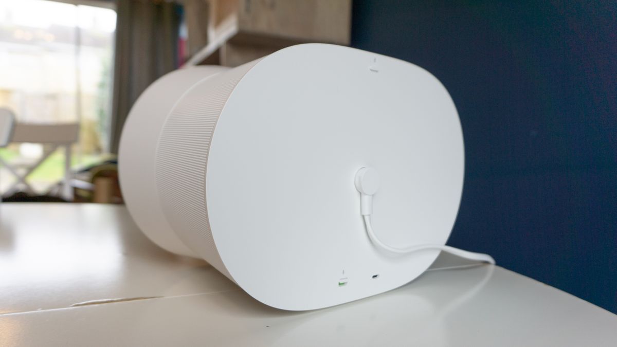 The rear of the Sonos Era 300, on white table. We can see its power connection, and a USB-C port for other connection. There is also a switch to disable the microphone