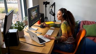 A podcaster using the Apple MacBook Pro M5
