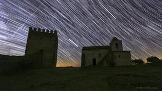 star trails over a castle